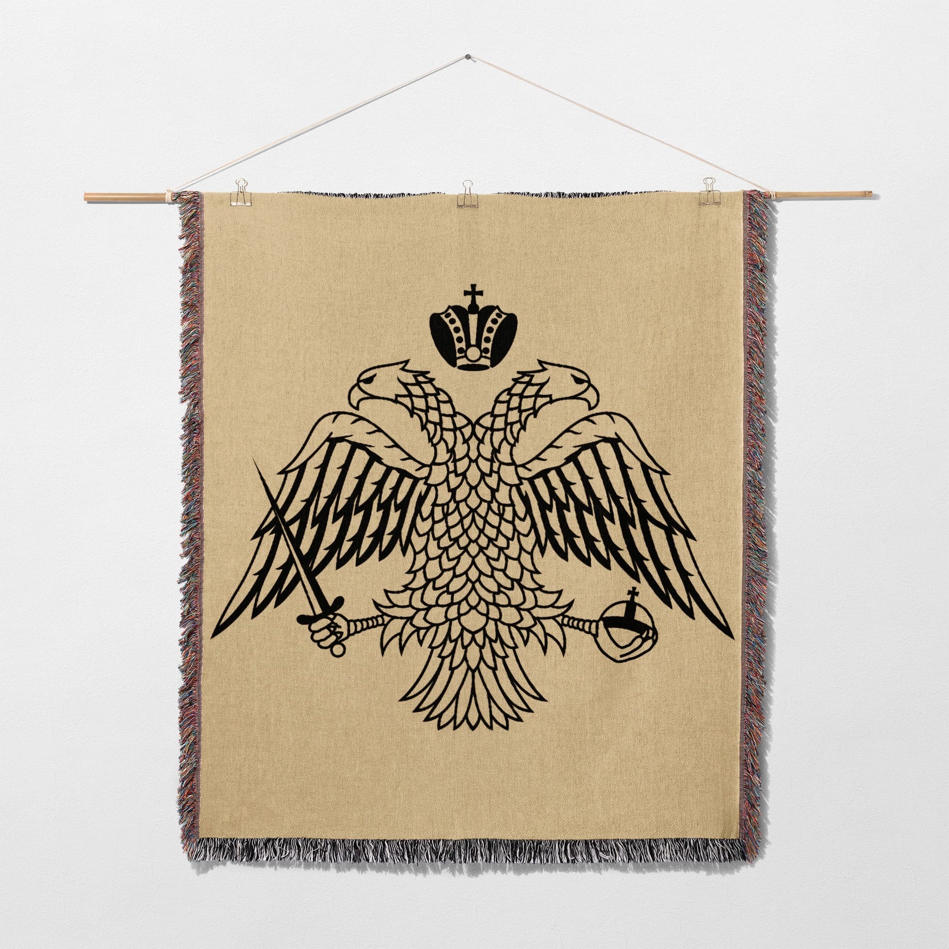 Double-headed eagle crest with crown, sword, and orb on woven tapestry.