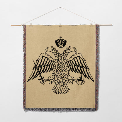 Double-headed eagle crest with crown, sword, and orb on woven tapestry.