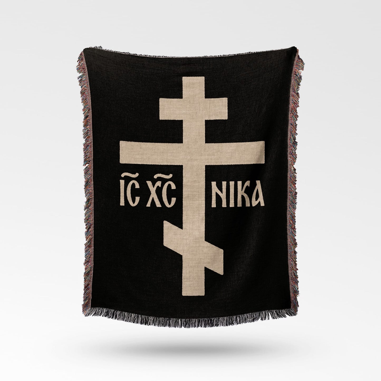 Black throw blanket with beige Eastern Orthodox cross and text.