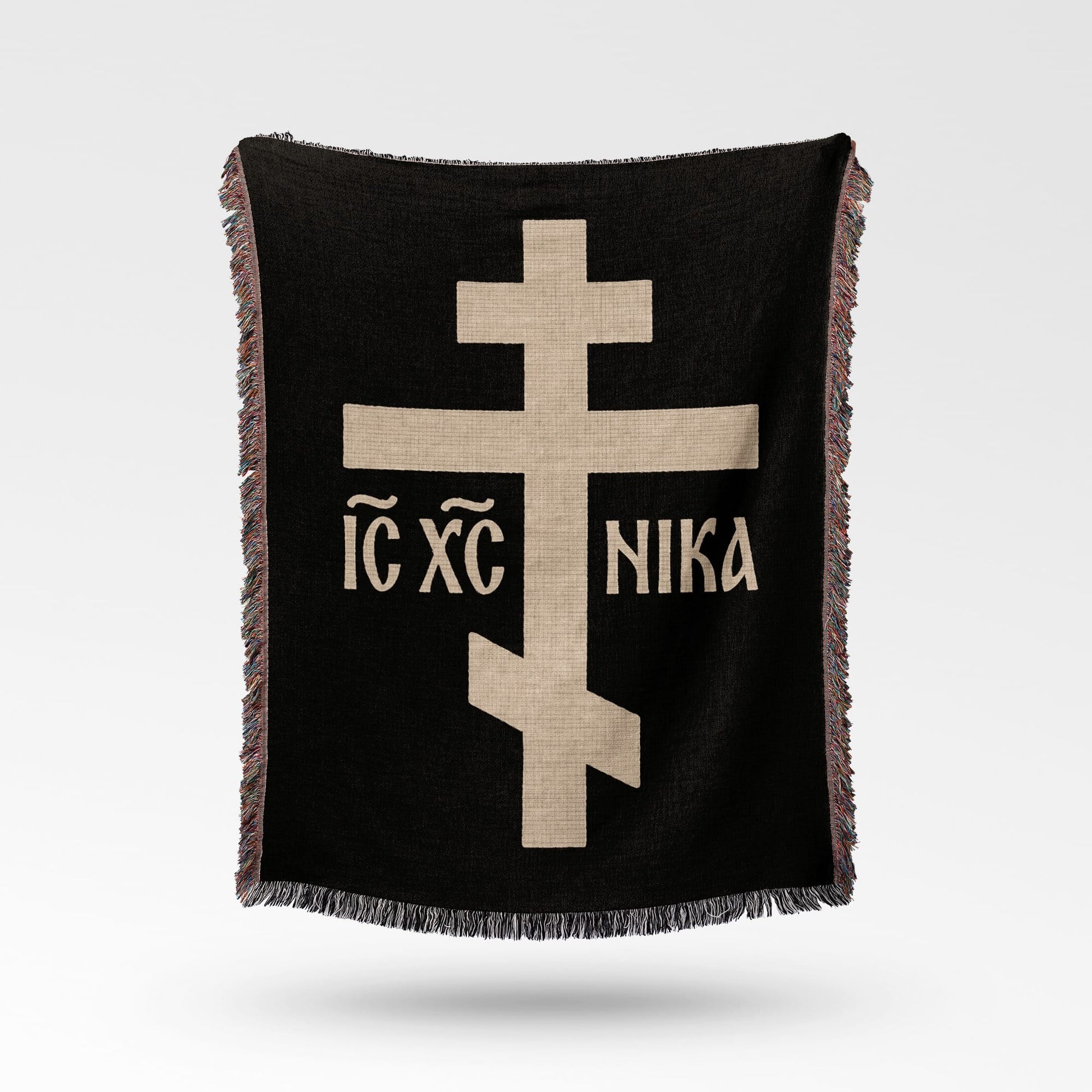 Black throw blanket with beige Eastern Orthodox cross and text.