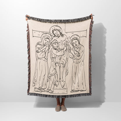 Tapestry blanket with line drawing of Christ's descent from the cross.