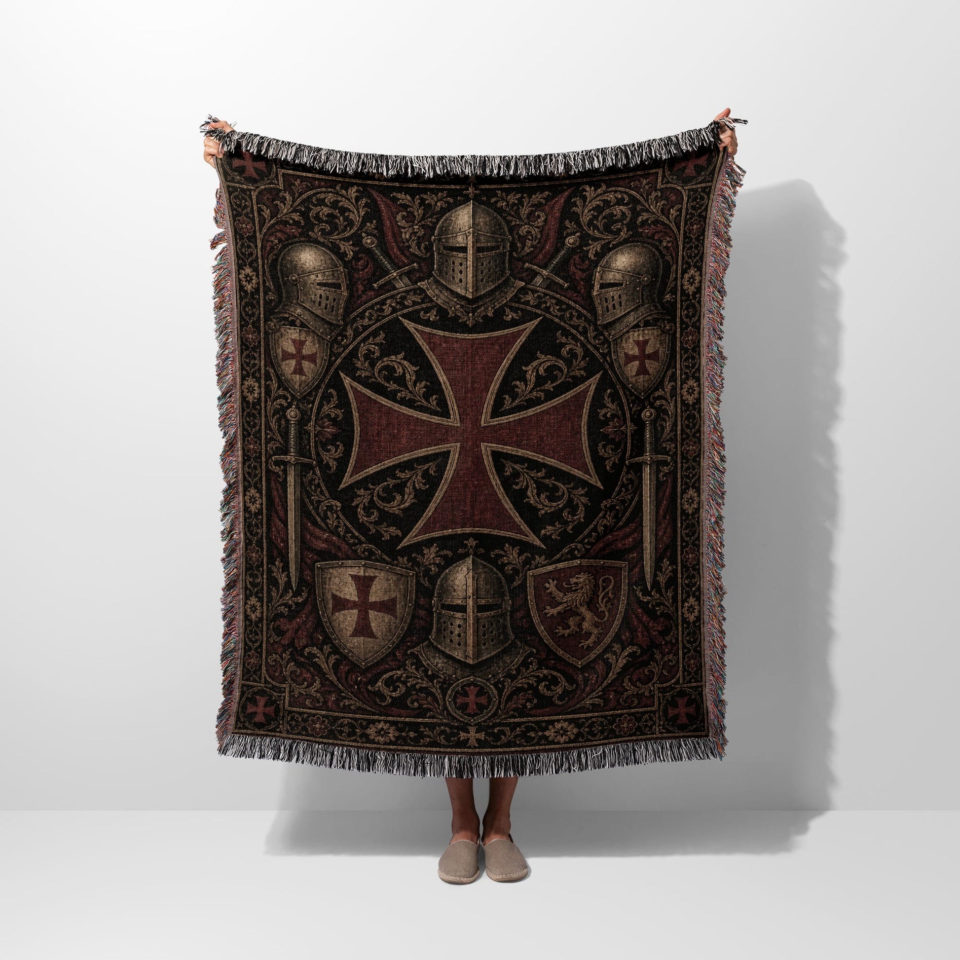 Tapestry throw with knights' helmets, shields, and a large Maltese cross.