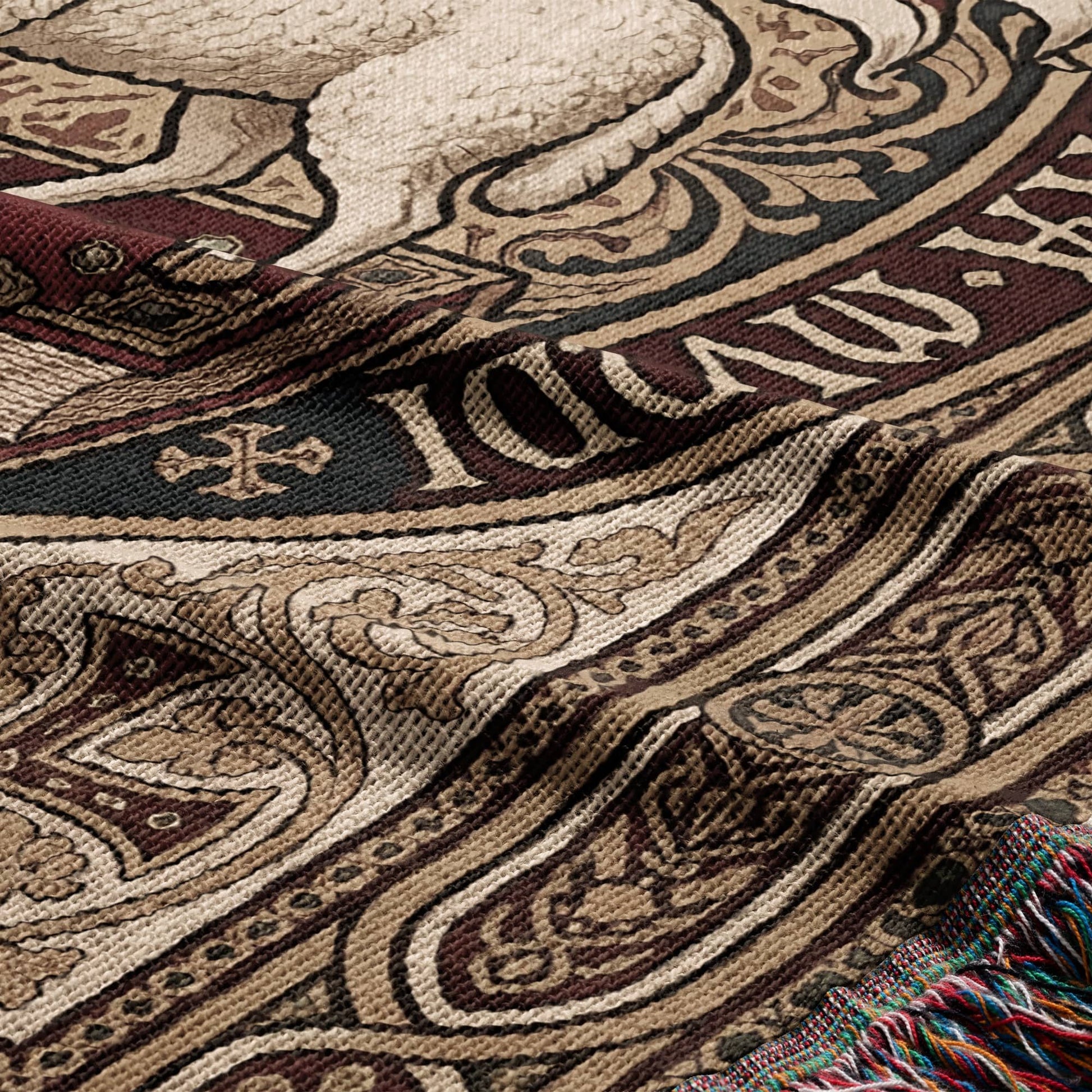 Close-up of woven tapestry featuring intricate medieval patterns and "THE" text.