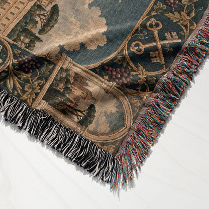 A woven tapestry throw blanket featuring a medieval landscape scene with multicolored fringe edges.