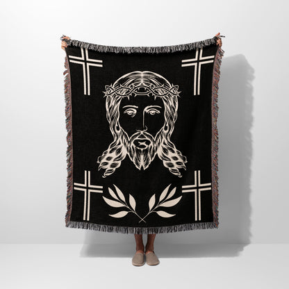 Black woven blanket with Jesus' face, crown of thorns, and crosses.