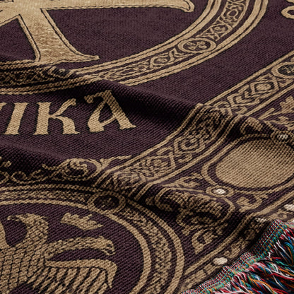 Woven tapestry with "AMIKA" text and ornate border detail, featuring fringed edge.