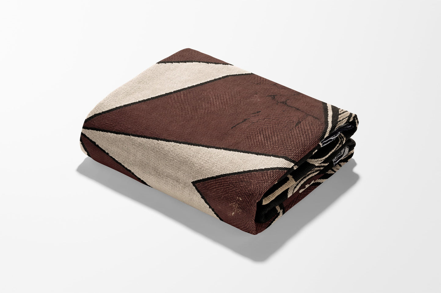 Folded brown and beige patterned throw blanket with black accents.