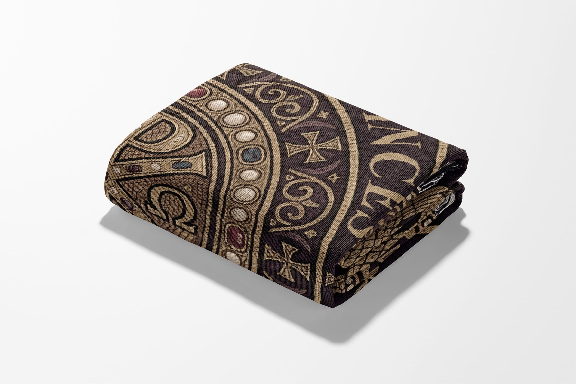 Folded blanket with a dark brown Celtic knot and cross design.