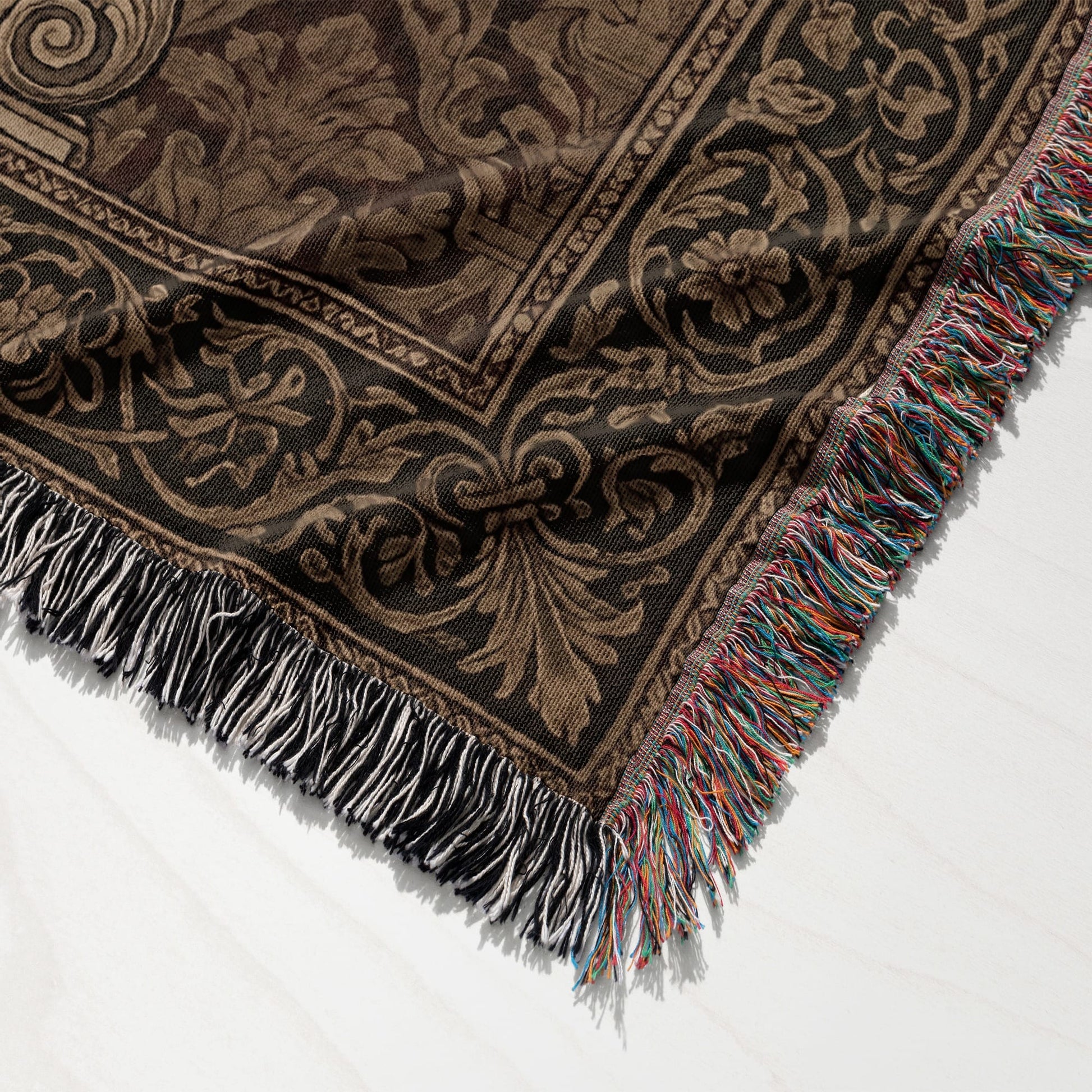 Brown and black patterned throw blanket with fringed edges and black, white, and multicolor tassels.