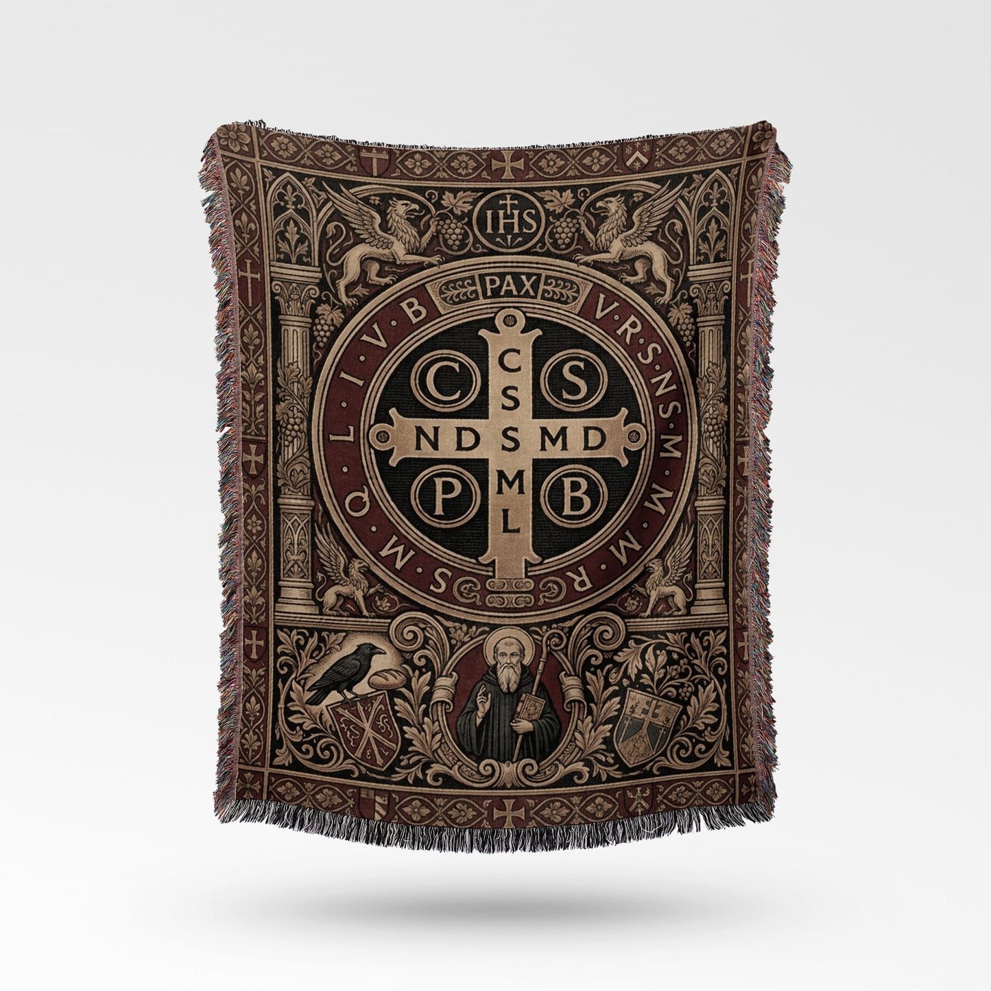 Tapestry throw with St. Benedict's medal, Pax, IHS, and ornate border designs.