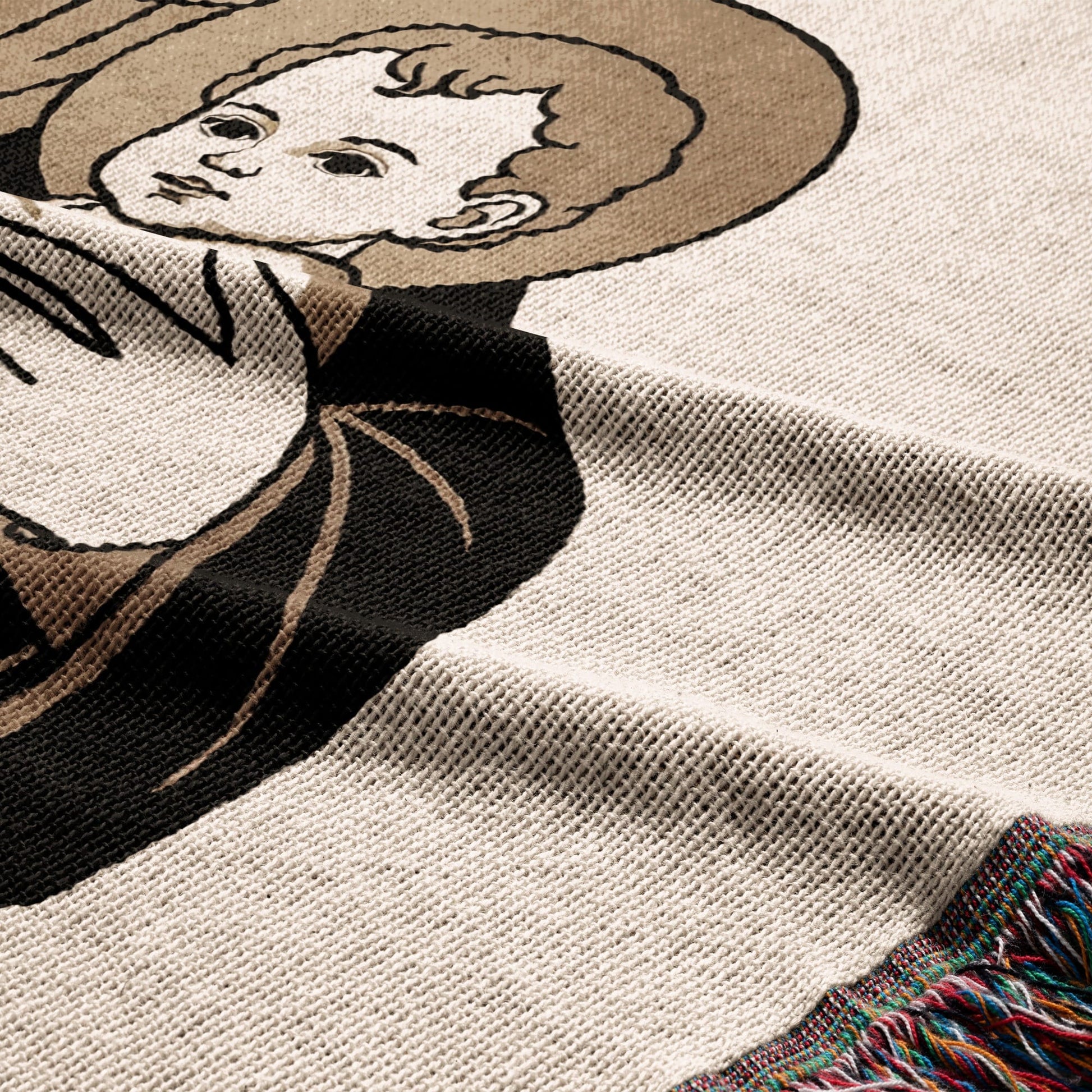 Woven blanket with a close-up of a religious figure's face and halo.