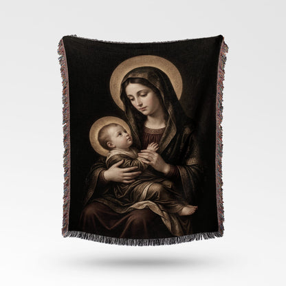 Religious artwork of the Madonna and Child displayed on a textured throw blanket.