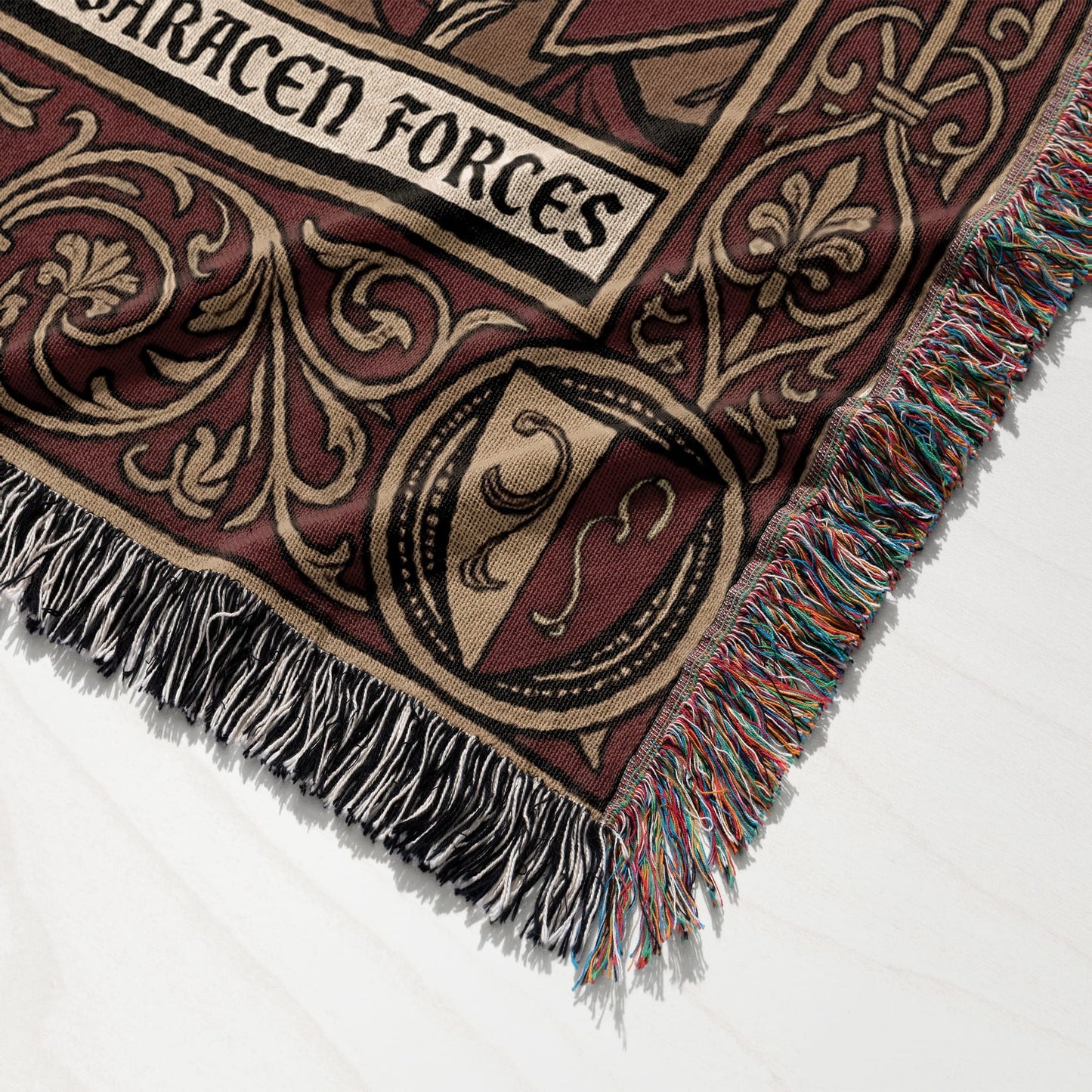 Woven blanket with ornate border and "Saracen Forces" text.