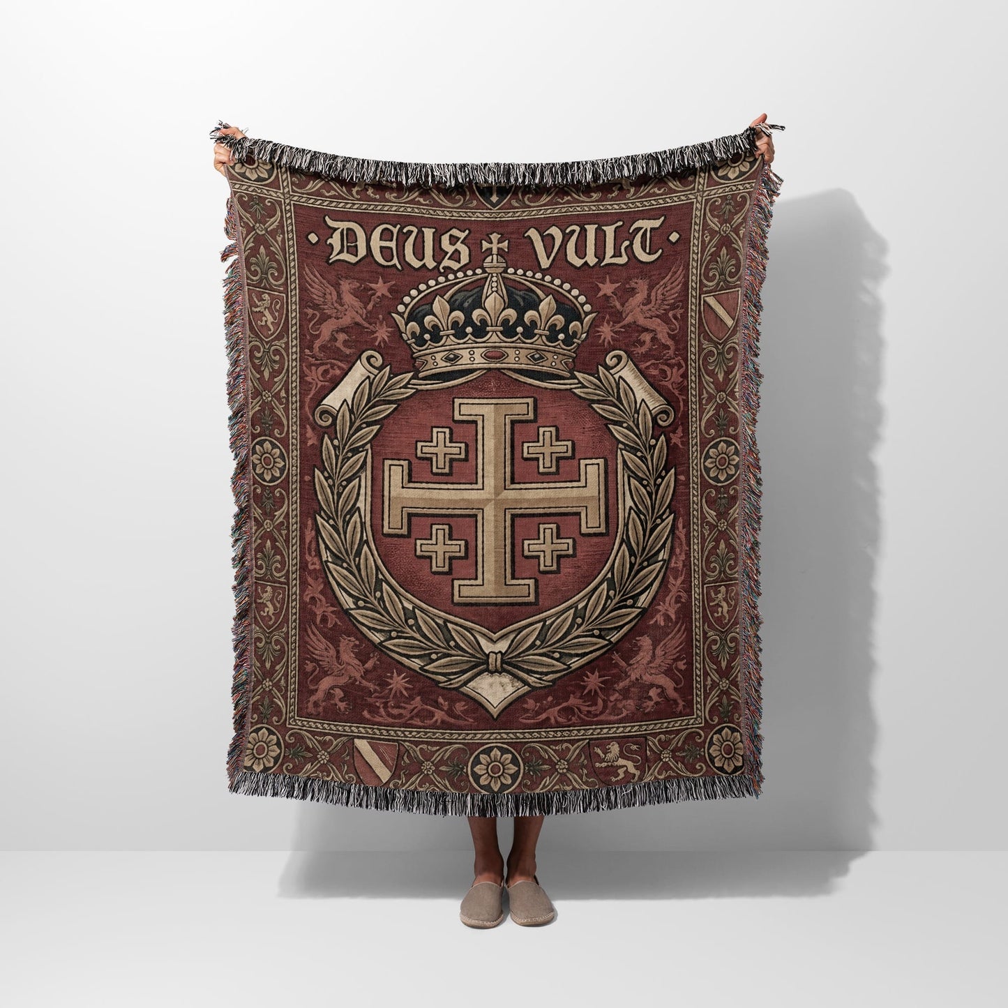 Tapestry throw with medieval crest, crown, and "DEUS VULT" text.