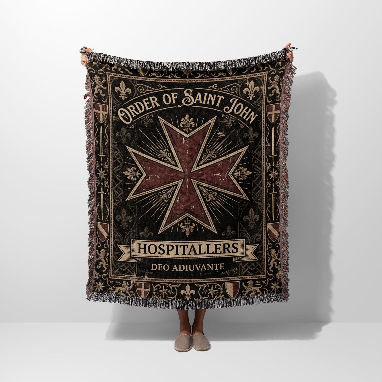 Tapestry blanket featuring Order of Saint John emblem and text.