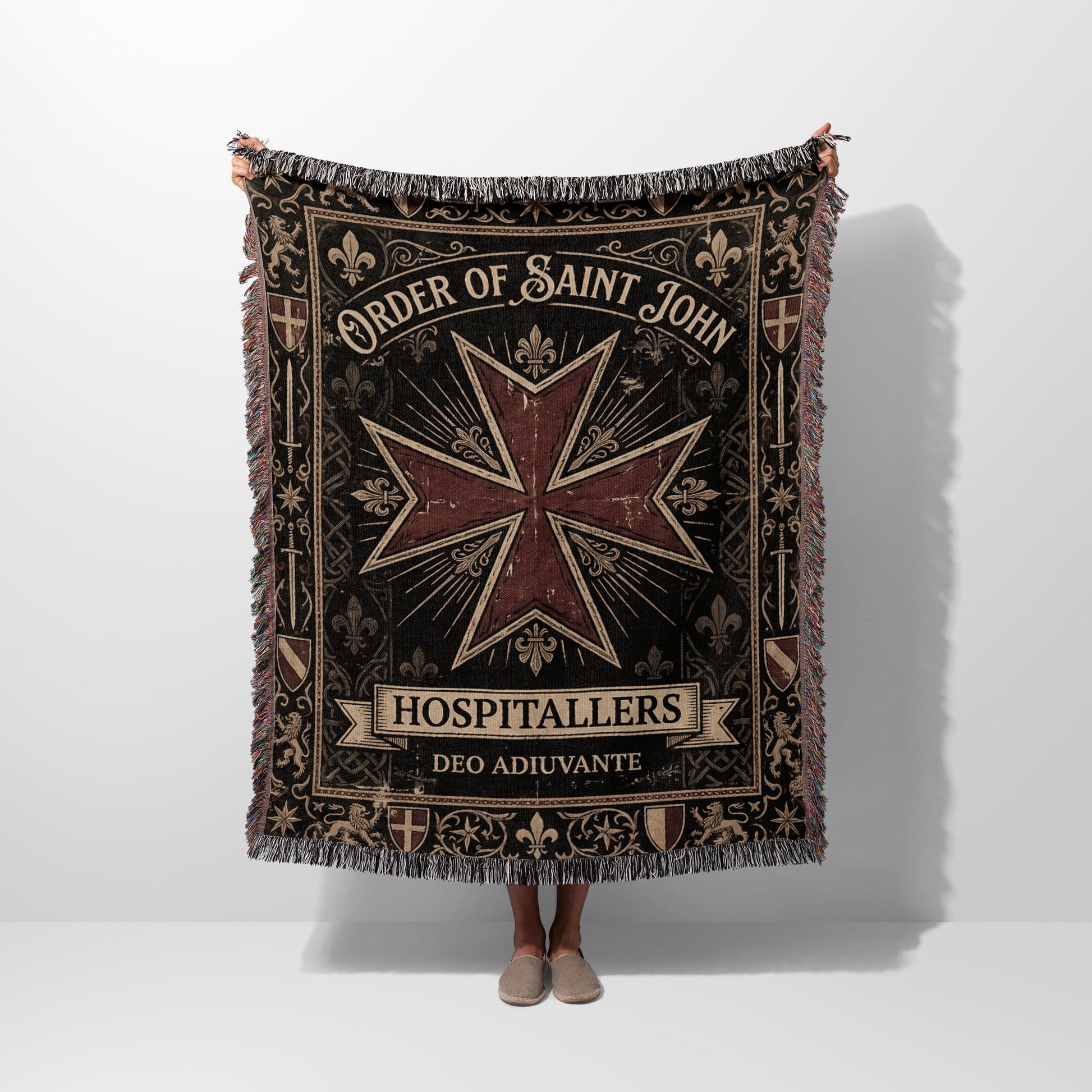 Tapestry blanket featuring Order of Saint John emblem and text.