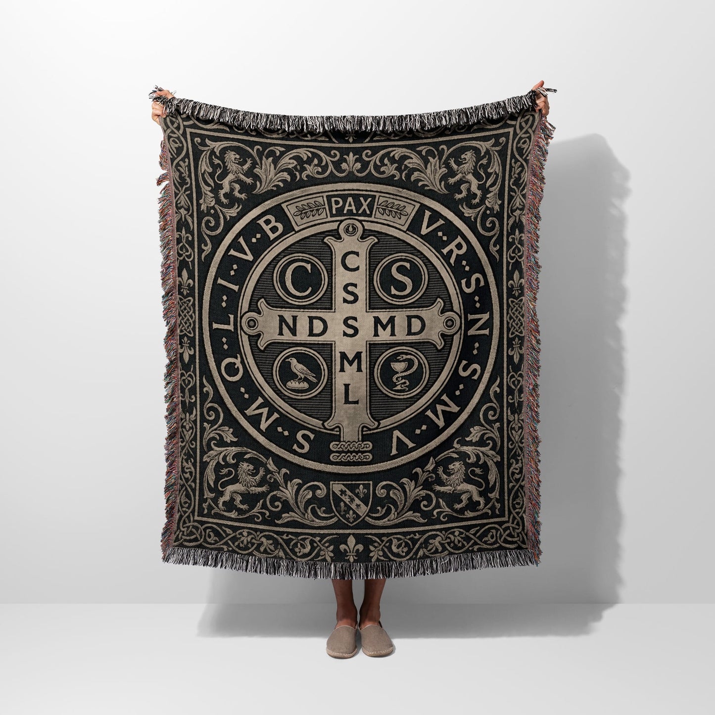 Woven blanket featuring a St. Benedict medal design with ornate border.