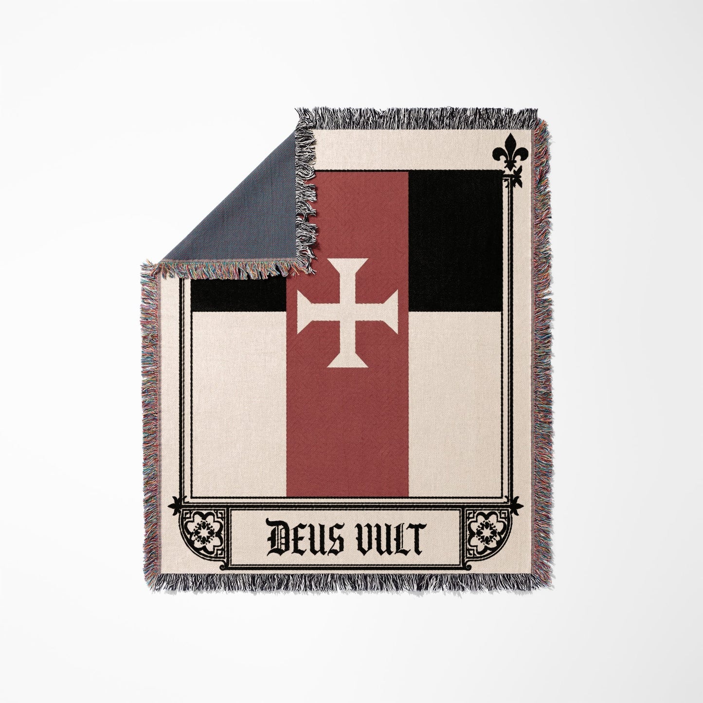 Woven blanket with white cross on red and black background, "Deus Vult" text.
