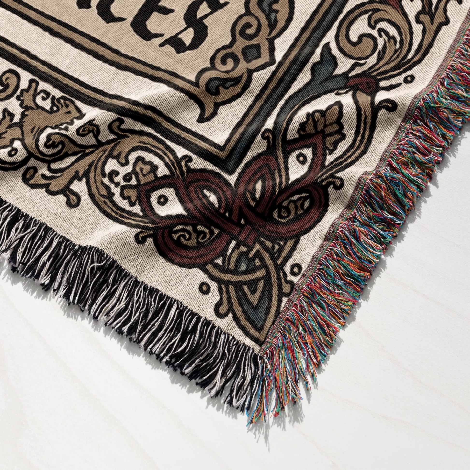 Woven blanket with Celtic knot design and fringed edges.