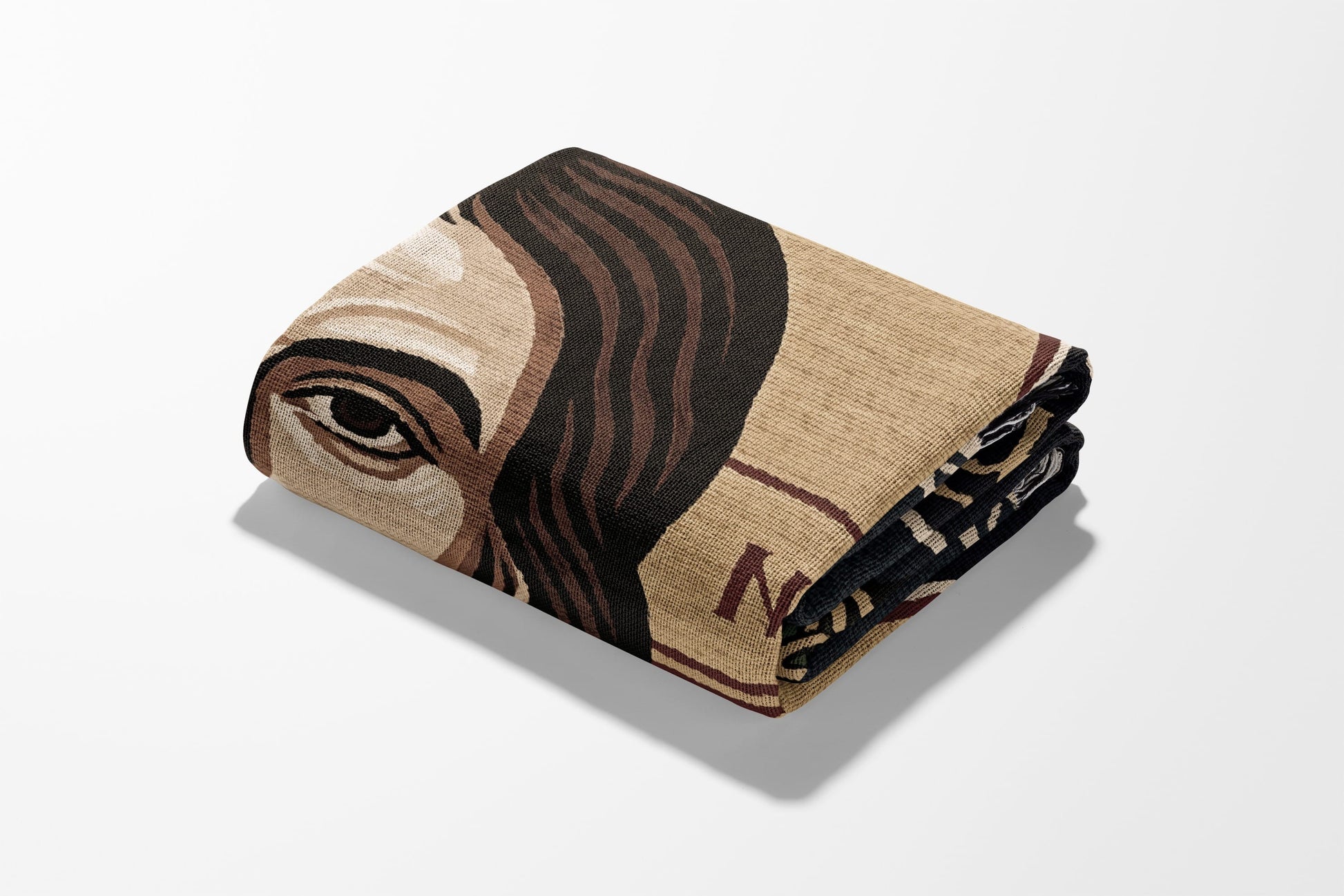 Folded blanket with portrait of a person and "N" text.