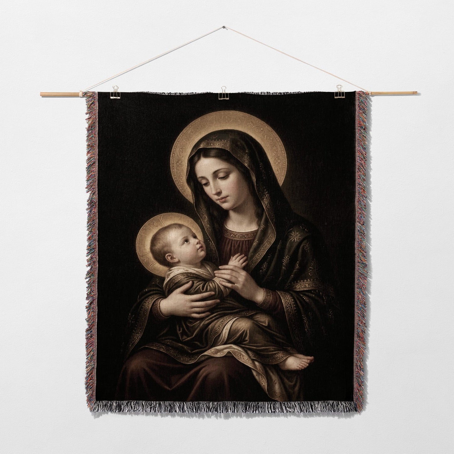 Madonna and Child artwork on a tapestry hanging on a white wall.