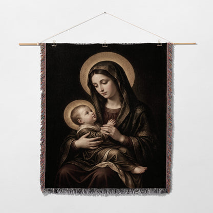 Madonna and Child artwork on a tapestry hanging on a white wall.