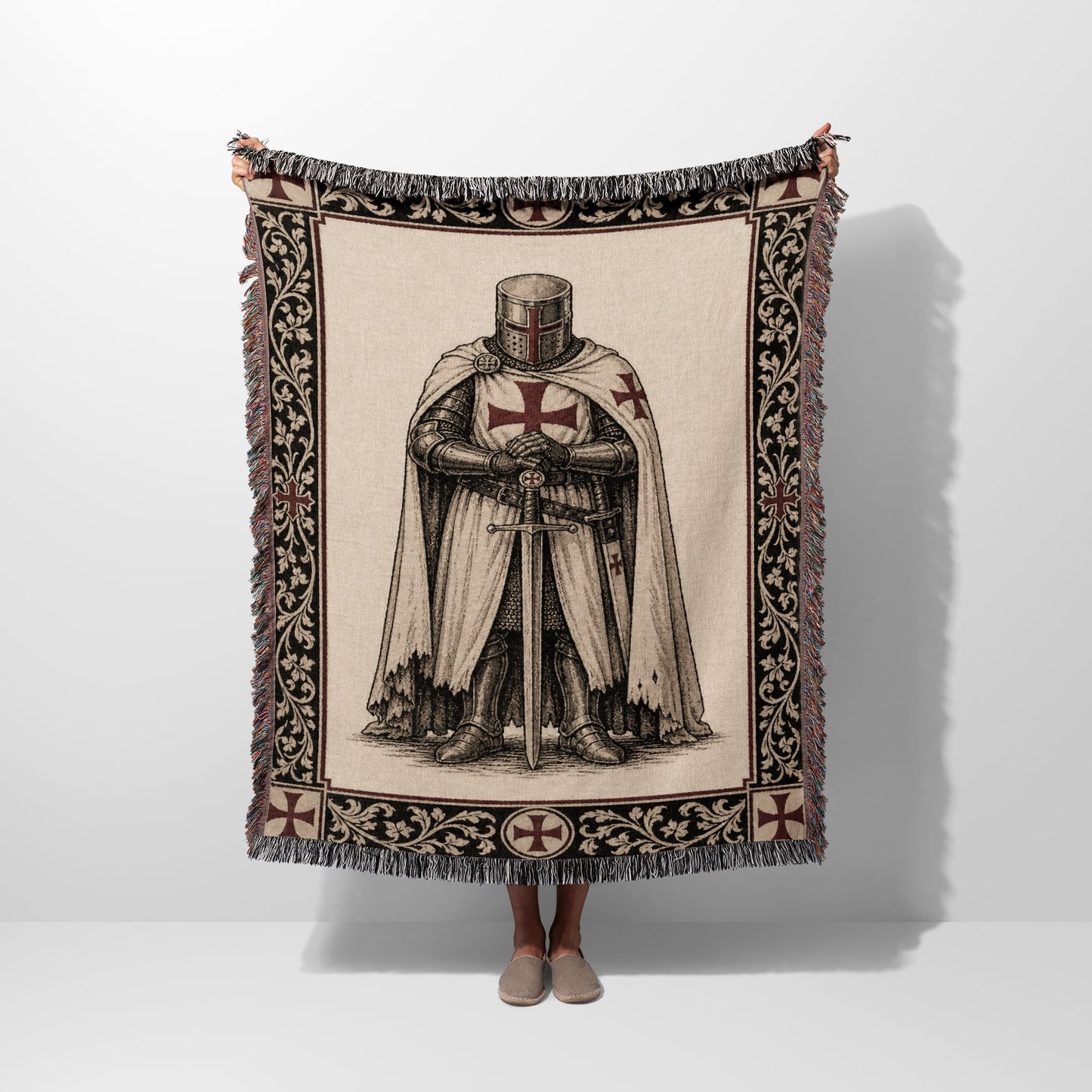 Tapestry blanket with a Templar knight design and fringe.