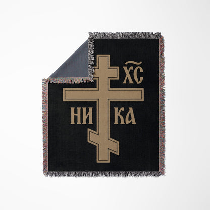 Black woven blanket with a gold Eastern Orthodox cross and "In Hoc Signo Vinces" inscription.