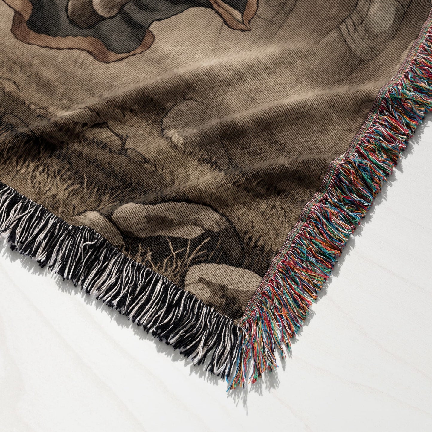 Woven throw blanket with fringed edges, featuring a nature scene design.