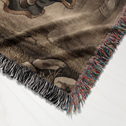 Woven throw blanket with fringed edges, featuring a nature scene design.