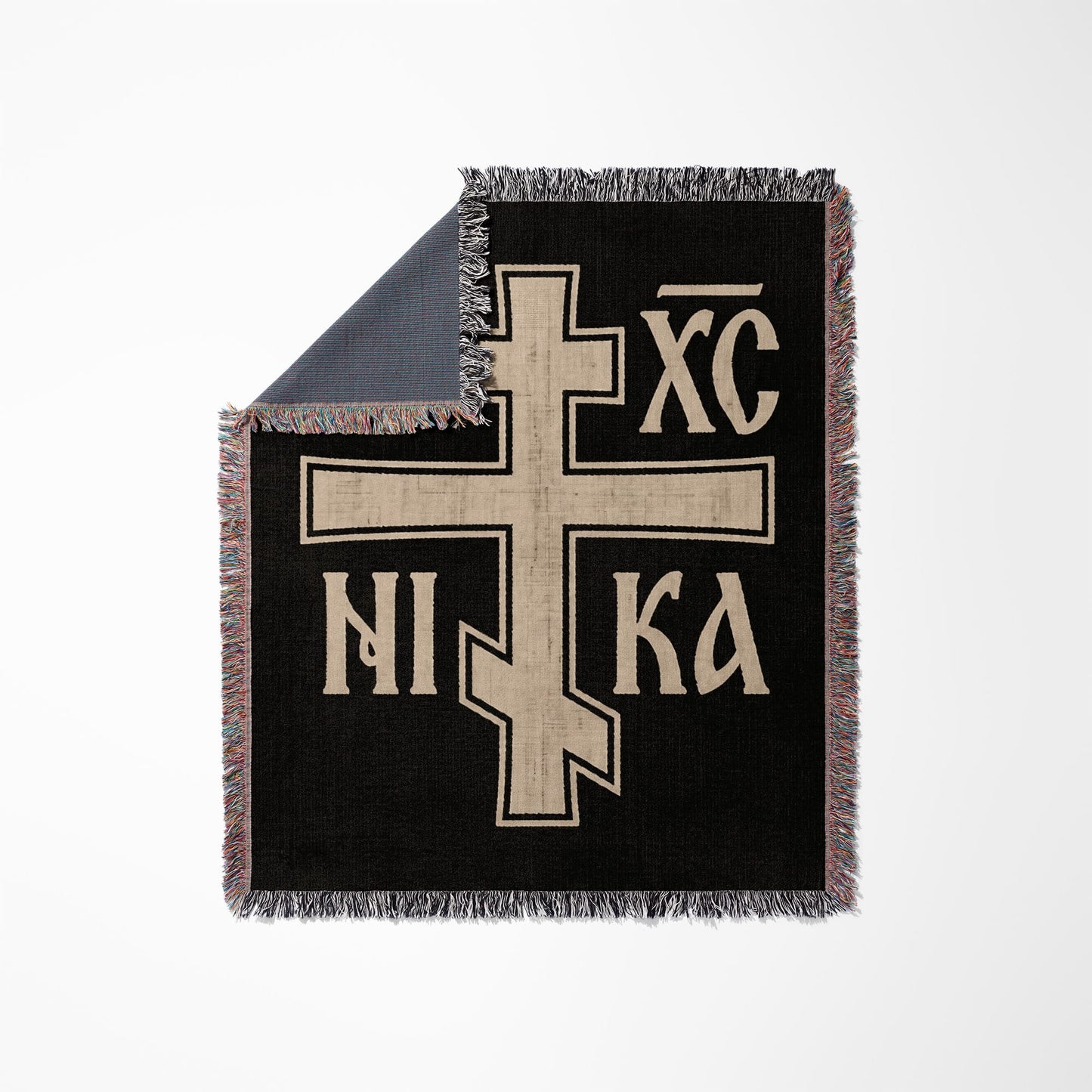 Black throw blanket with a large beige Orthodox Christian cross symbol.