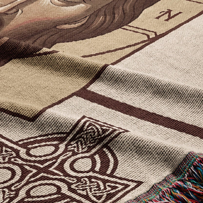 Close-up of a woven tapestry with Celtic knot designs and a partial human face.