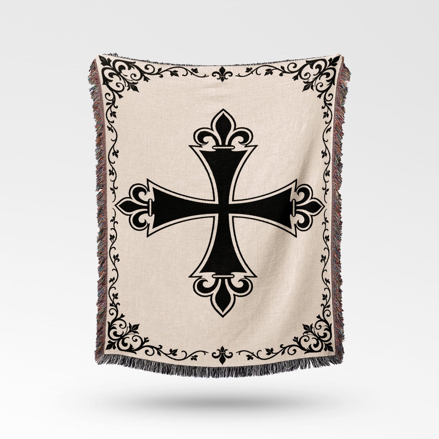 Cream woven blanket with black ornate cross and decorative border.