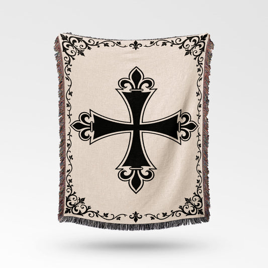 Cream woven blanket with black ornate cross and decorative border.