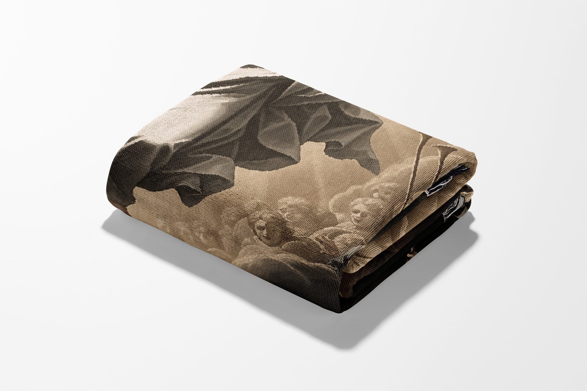 Folded throw blanket with ornate classical artwork in sepia tones.