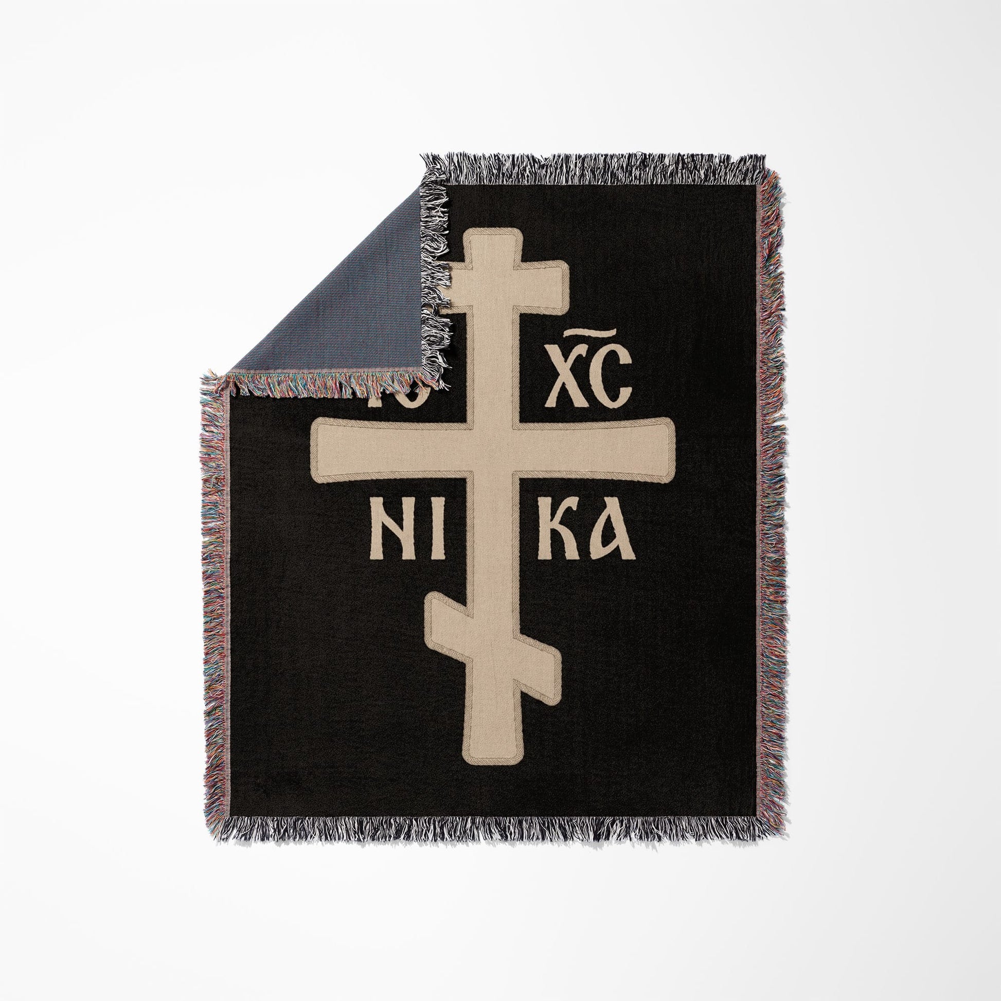 Black woven blanket with a tan Orthodox Christian cross and Greek initials IC XC NIKA.