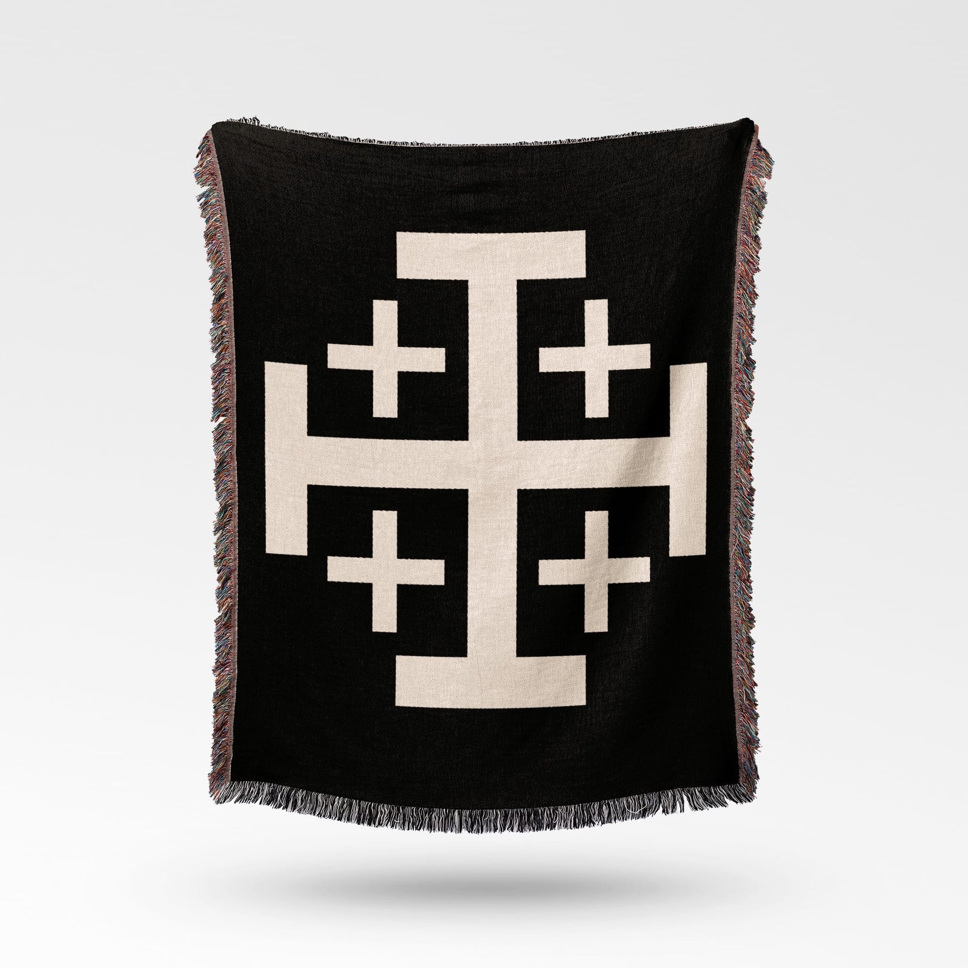 Black woven throw blanket with a large cream Jerusalem cross pattern.