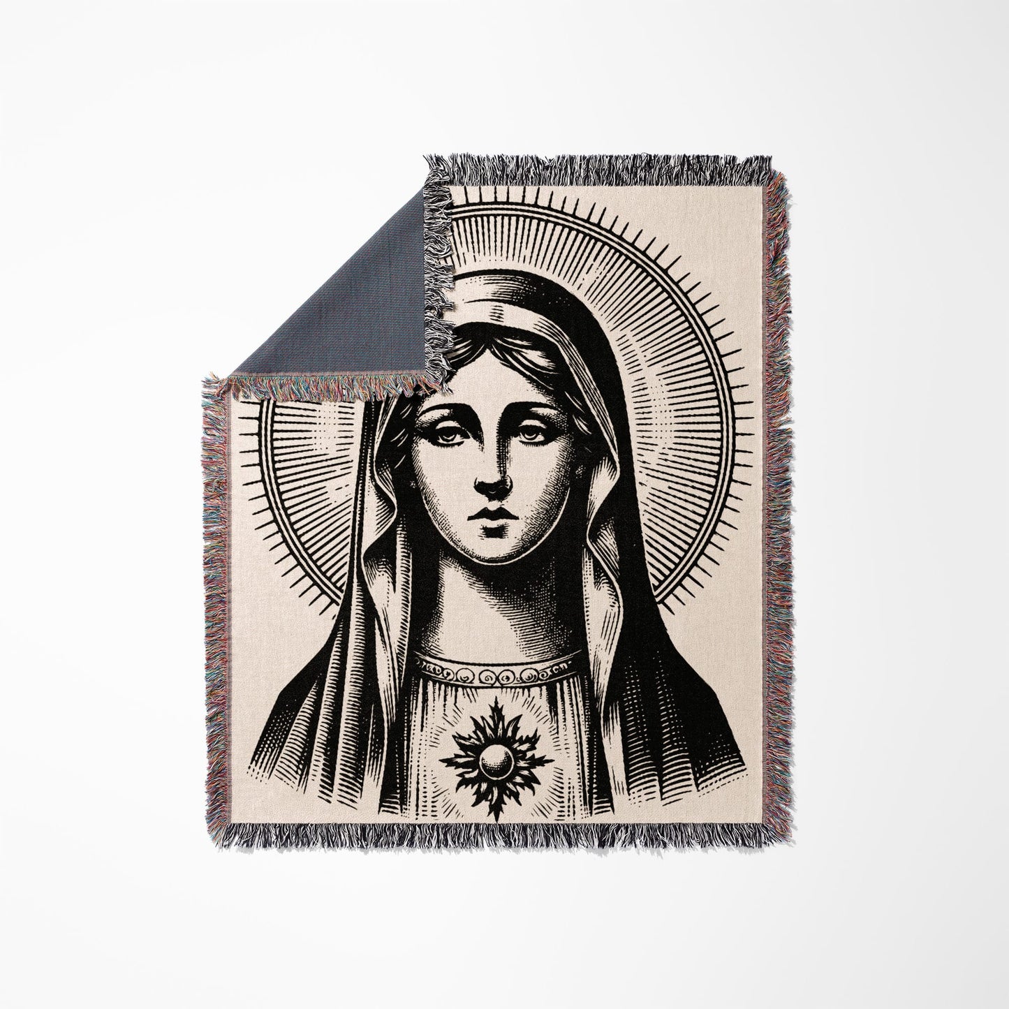 Blanket with a black and white engraving of the Virgin Mary with a halo.