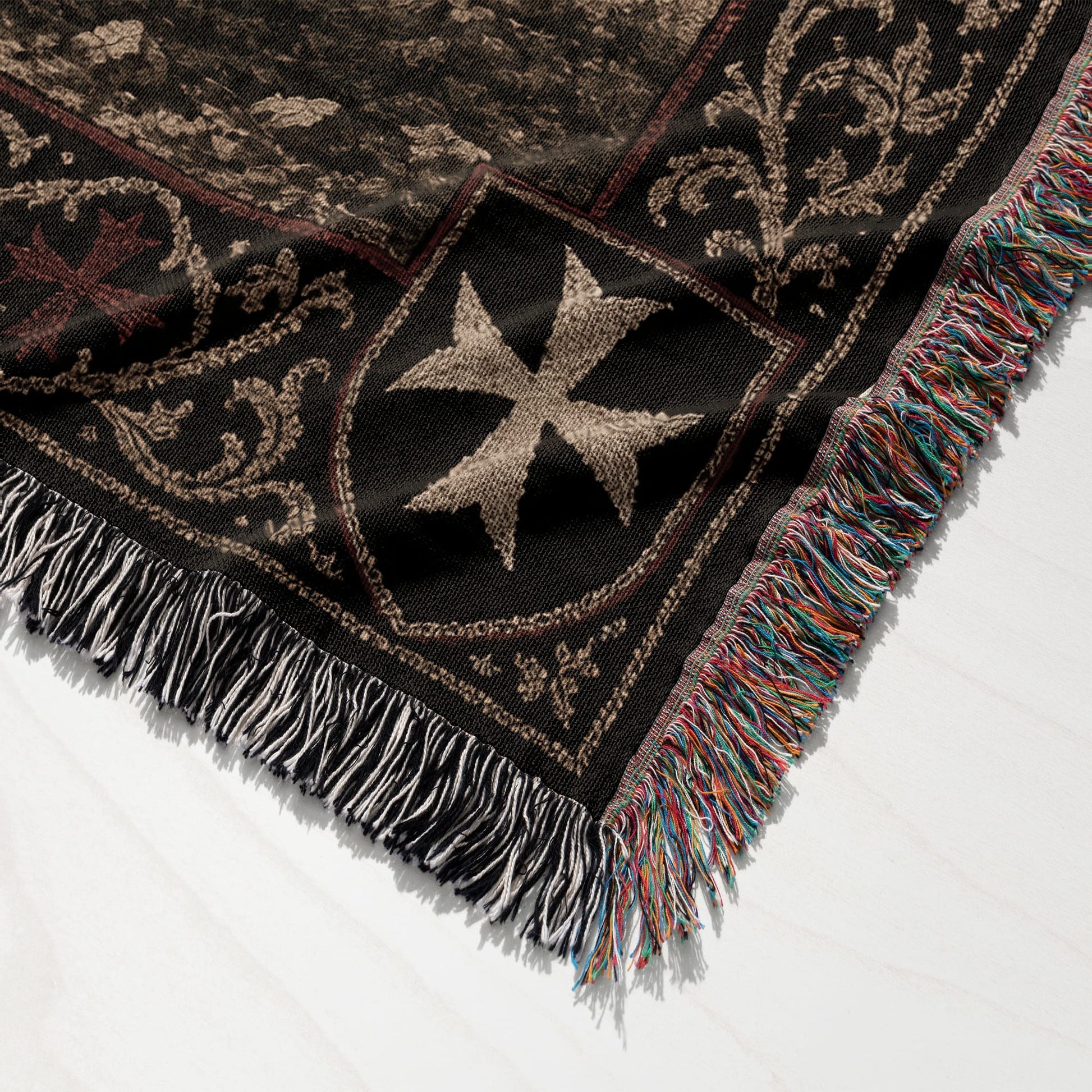 Tapestry blanket with Knights Templar cross and colorful fringe.