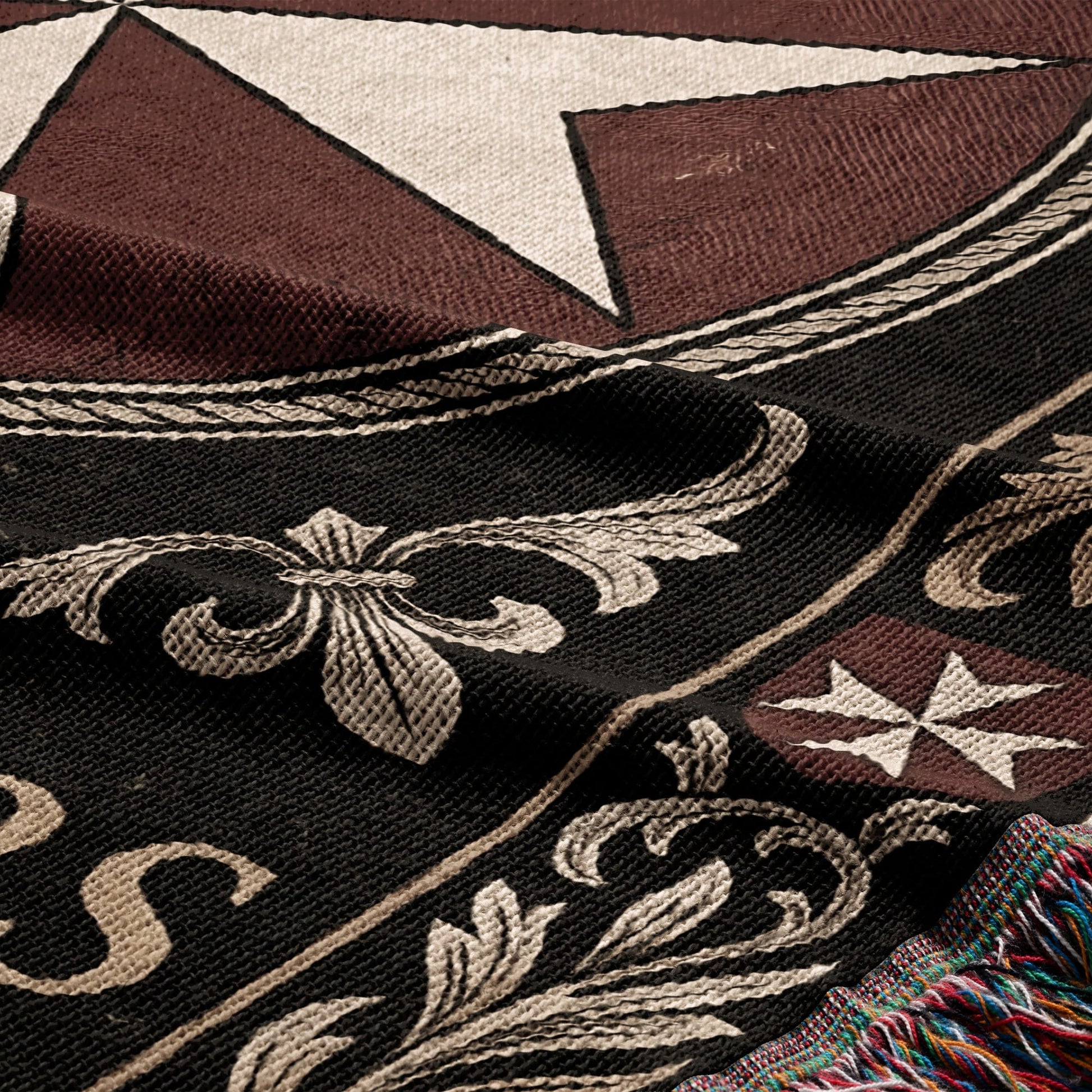 Black textile with ornate cream scrolling, white star, and Maltese cross.