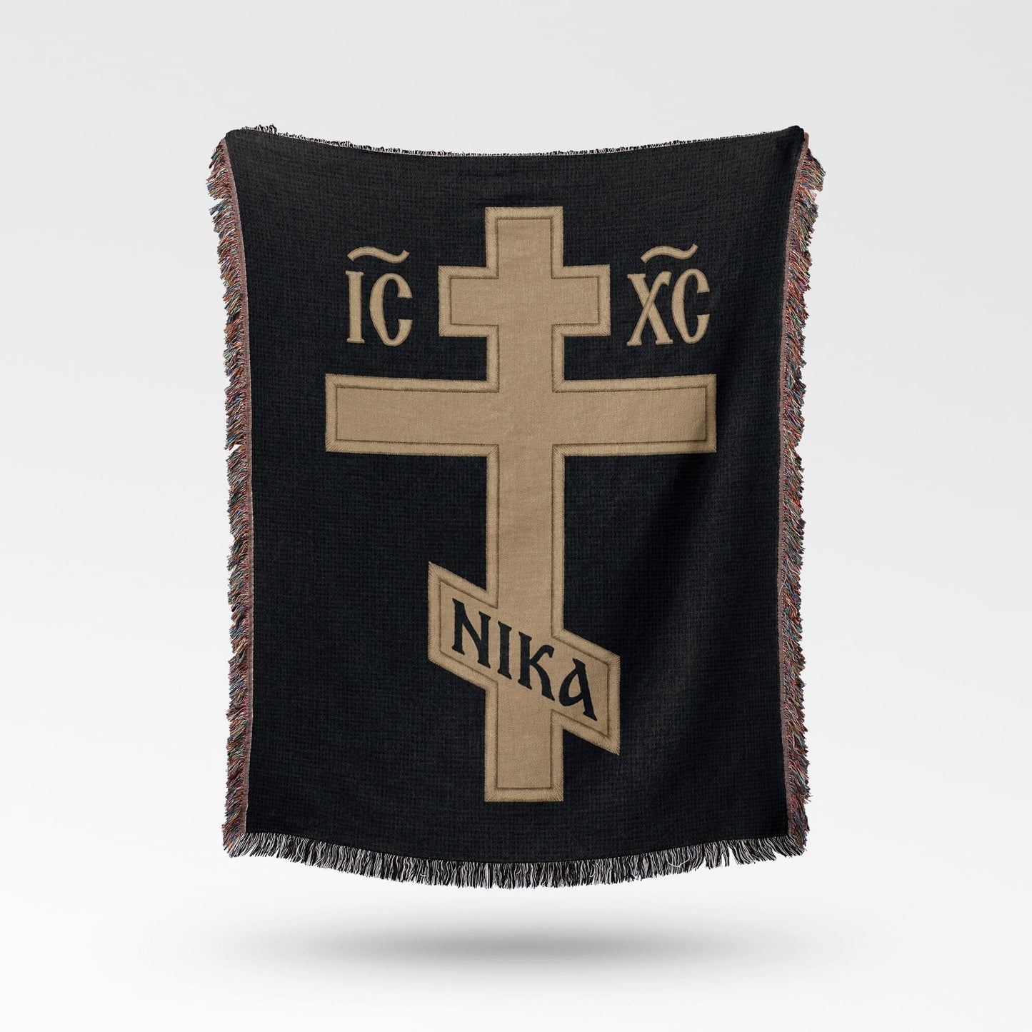 Black woven blanket with gold cross symbol and Greek letters IC XC NIKA.