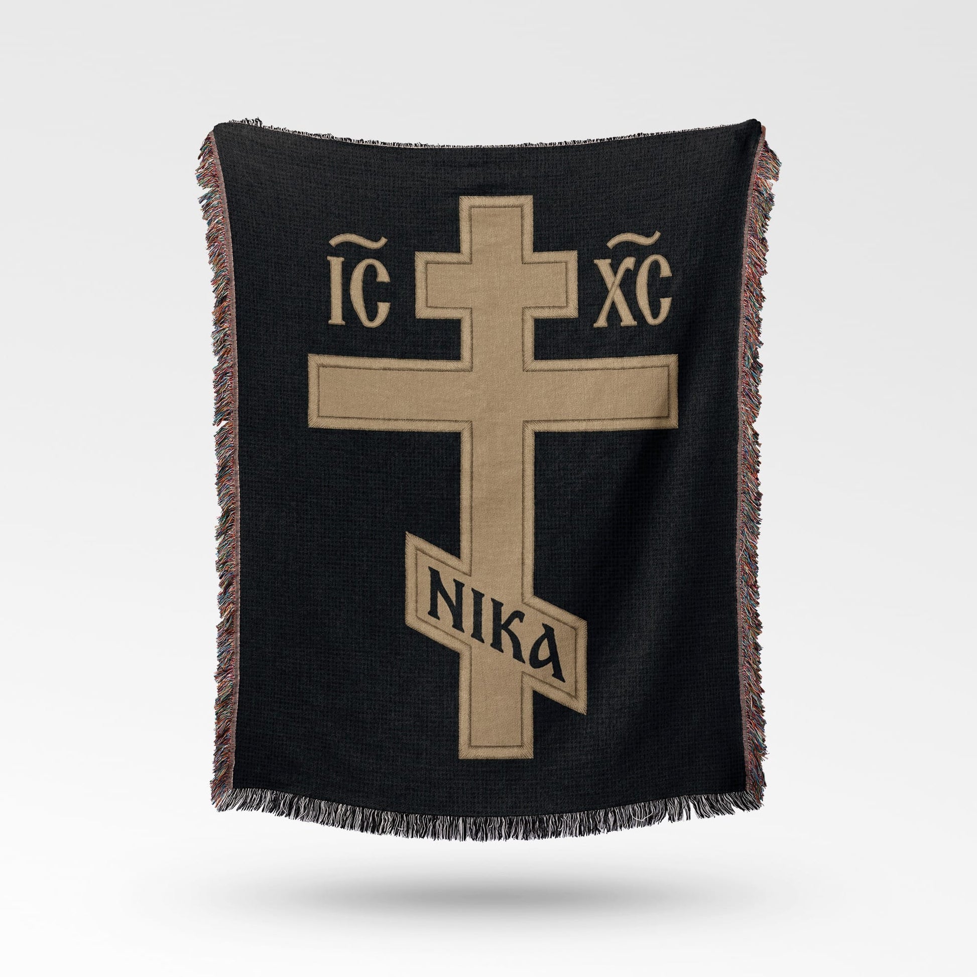 Black woven blanket with gold cross symbol and Greek letters IC XC NIKA.