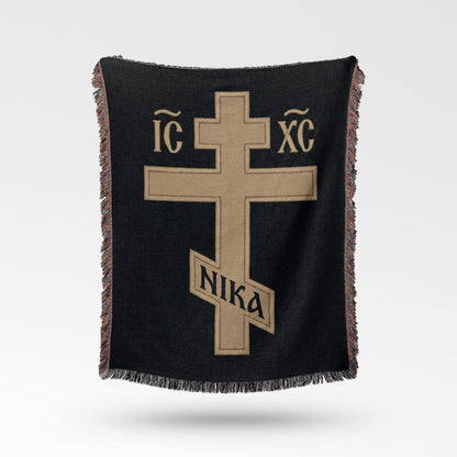 Black woven blanket with gold cross symbol and Greek letters IC XC NIKA.