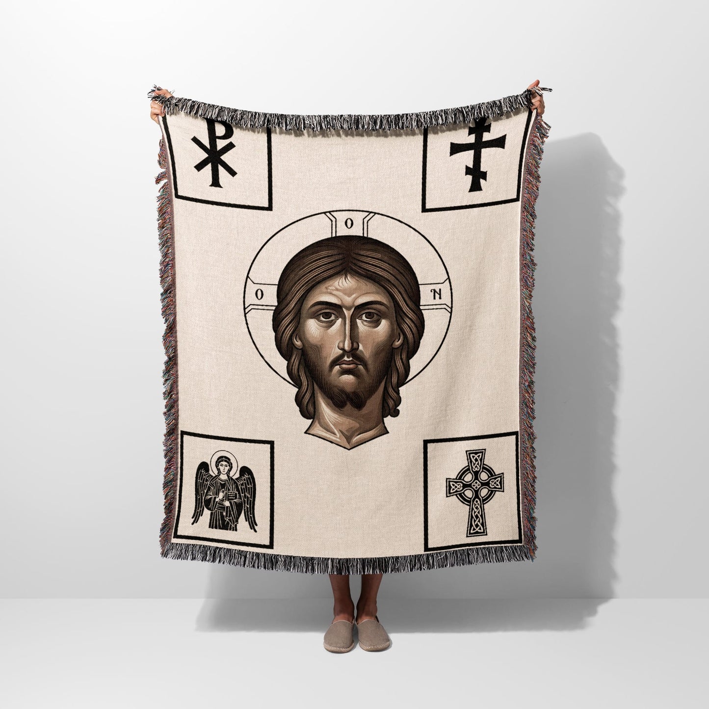 Woven throw depicting a portrait of Jesus surrounded by Christian symbols.