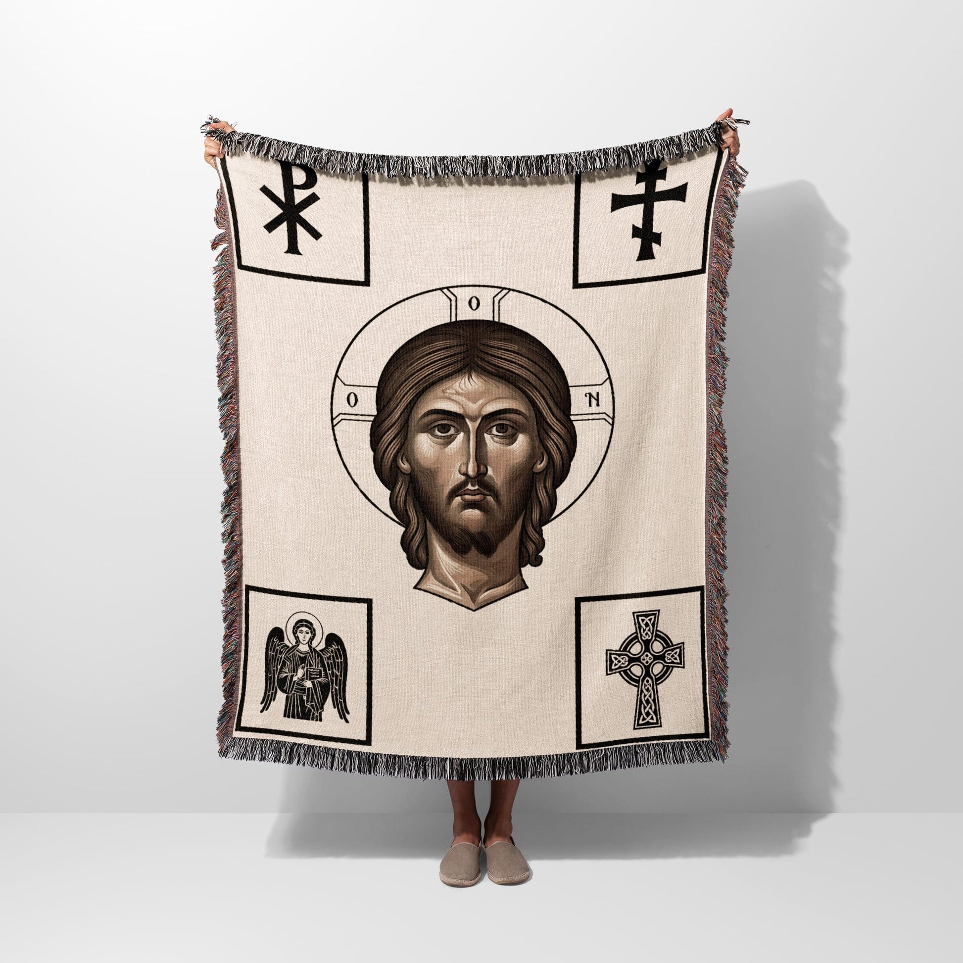 Woven throw depicting a portrait of Jesus surrounded by Christian symbols.