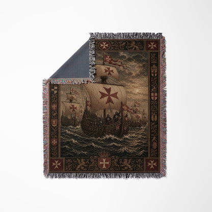 Woven blanket depicting a fleet of galleons with red crosses, framed by ornate patterns.
