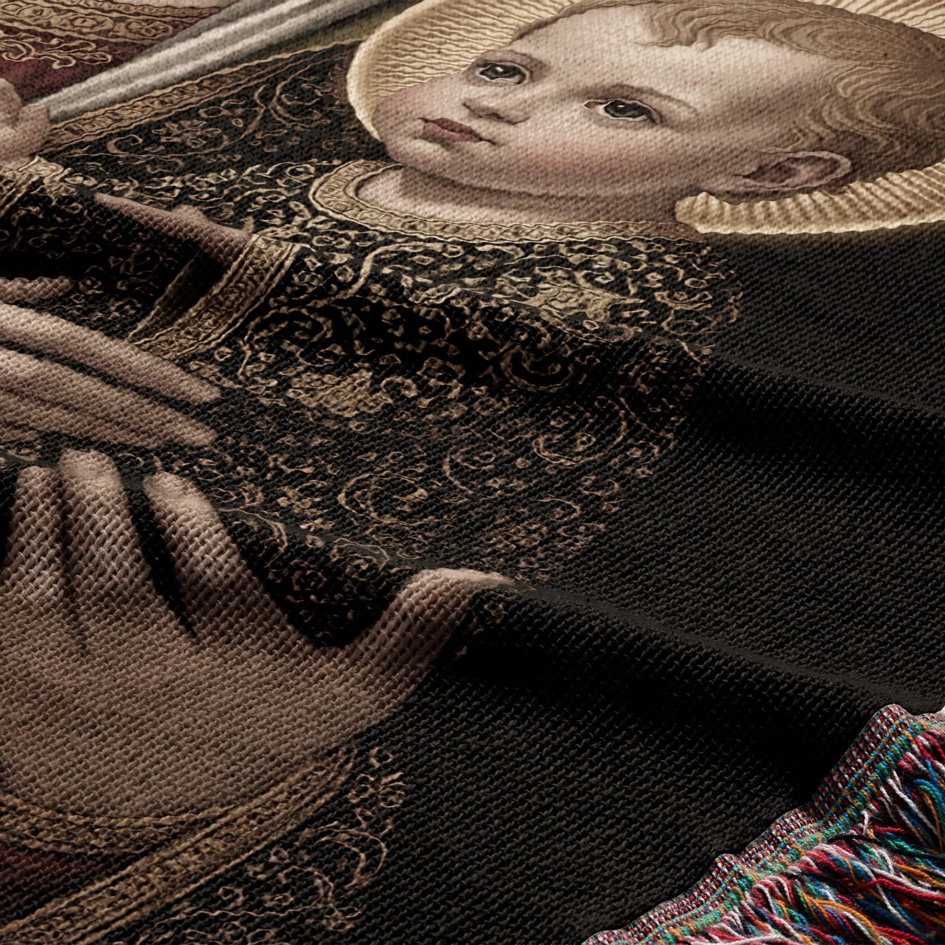 Detail of a tapestry depicting a young child with a halo and ornate fabric.