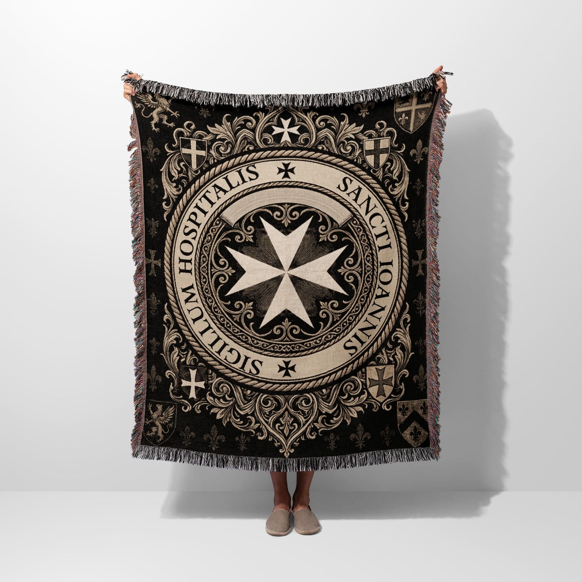 Tapestry throw with Knights of Malta emblem and scrolling details on black background.