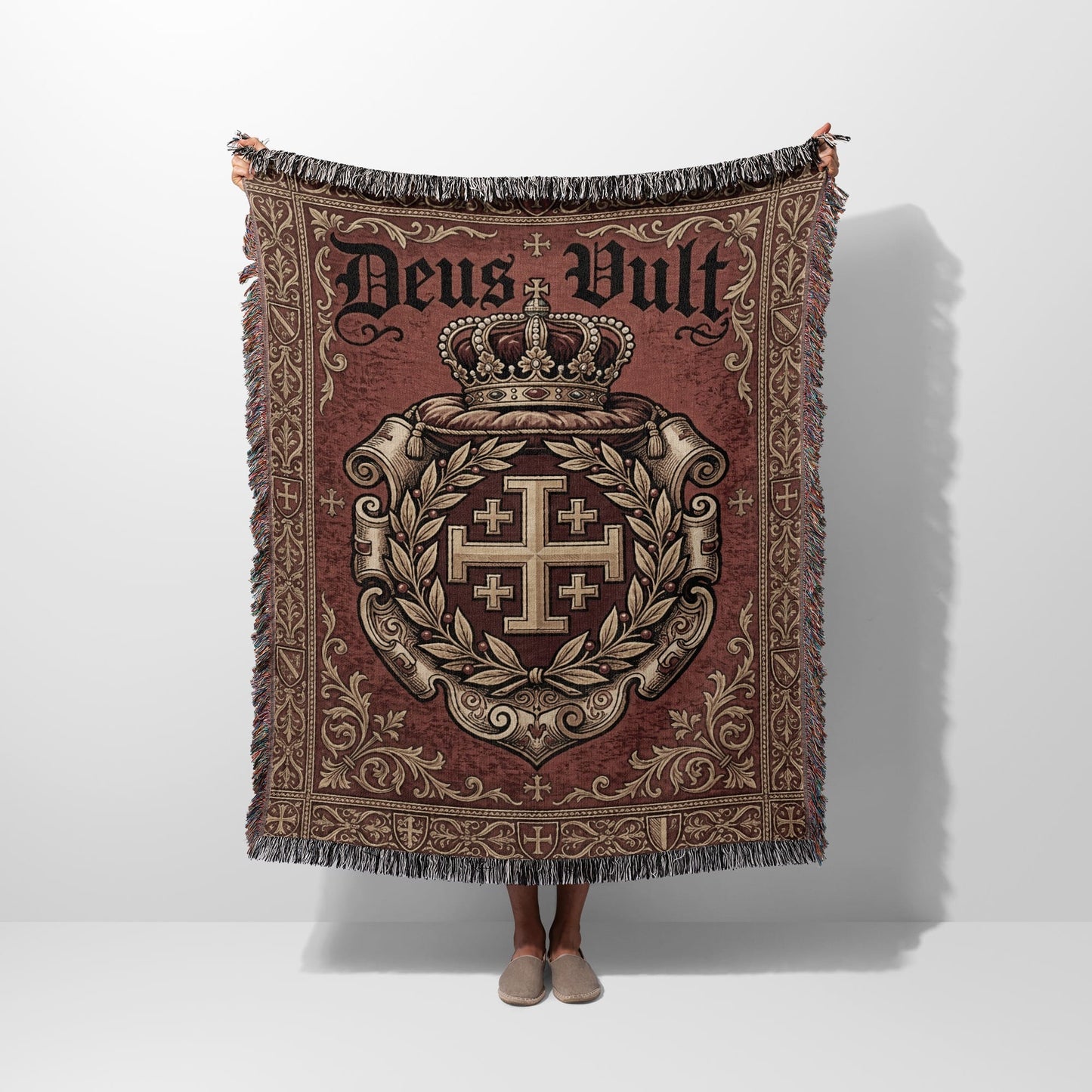 Woven tapestry throw with a crown, Jerusalem cross, and "Deus Vult" text.