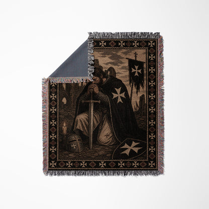 Templar knight kneeling with sword and shield, tapestry blanket.